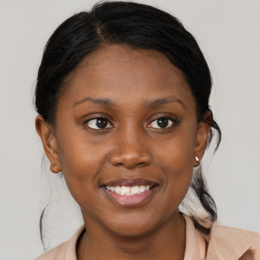 Joyful black young-adult female with medium  brown hair and brown eyes