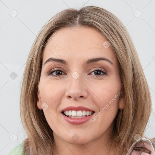 Joyful white young-adult female with medium  brown hair and green eyes