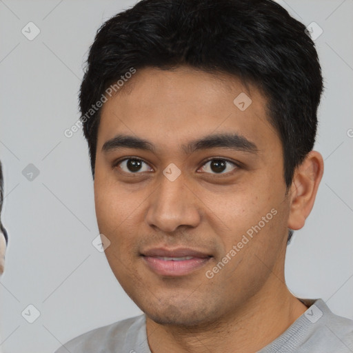 Joyful latino young-adult male with short  black hair and brown eyes