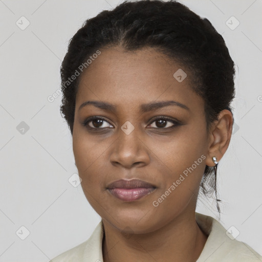 Joyful black young-adult female with short  black hair and brown eyes