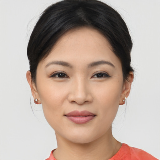 Joyful asian young-adult female with medium  black hair and brown eyes