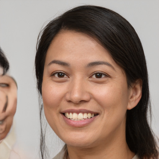 Joyful white young-adult female with medium  brown hair and brown eyes
