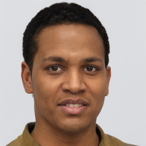 Joyful black young-adult male with short  black hair and brown eyes