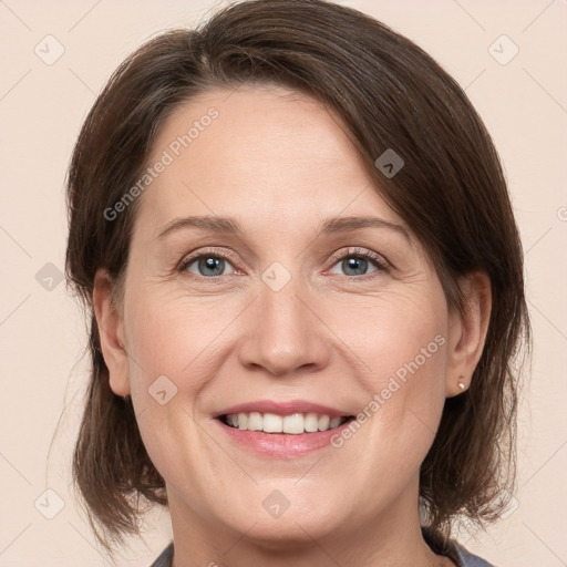 Joyful white adult female with medium  brown hair and grey eyes