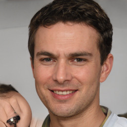 Joyful white adult male with short  brown hair and brown eyes