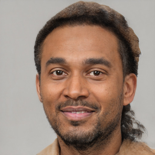 Joyful latino adult male with short  brown hair and brown eyes