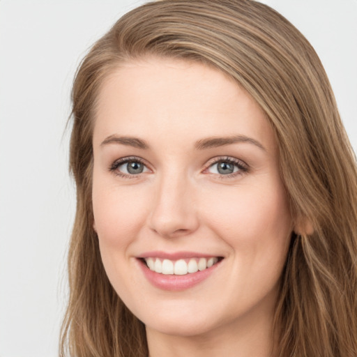 Joyful white young-adult female with long  brown hair and green eyes