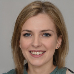 Joyful white young-adult female with medium  brown hair and blue eyes