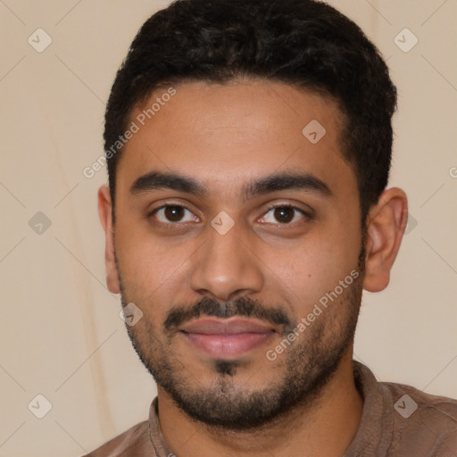 Joyful latino young-adult male with short  black hair and brown eyes