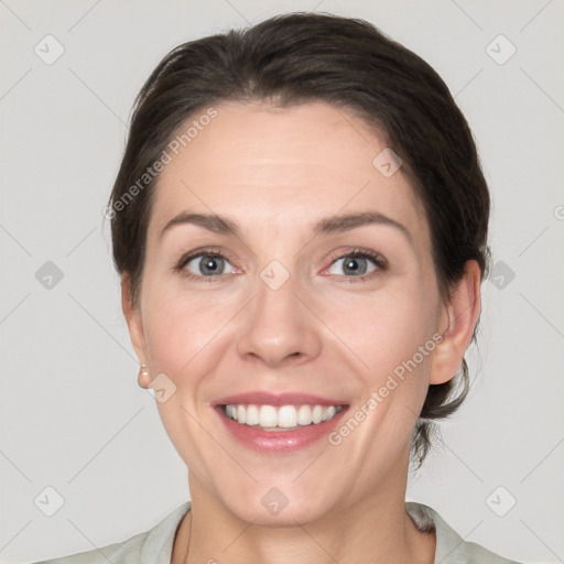 Joyful white young-adult female with medium  brown hair and grey eyes