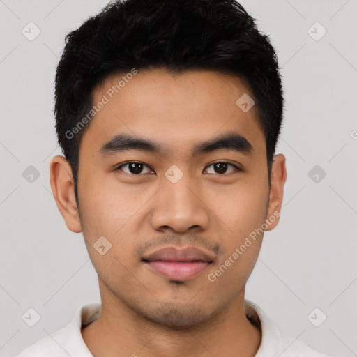 Joyful latino young-adult male with short  black hair and brown eyes