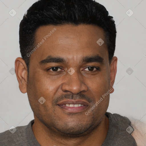 Joyful black young-adult male with short  black hair and brown eyes