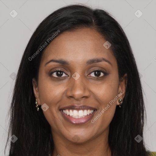 Joyful black young-adult female with long  brown hair and brown eyes