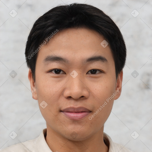 Joyful asian young-adult male with short  black hair and brown eyes