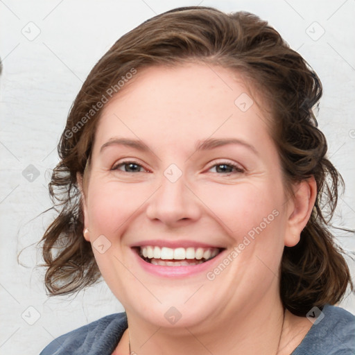 Joyful white young-adult female with medium  brown hair and blue eyes