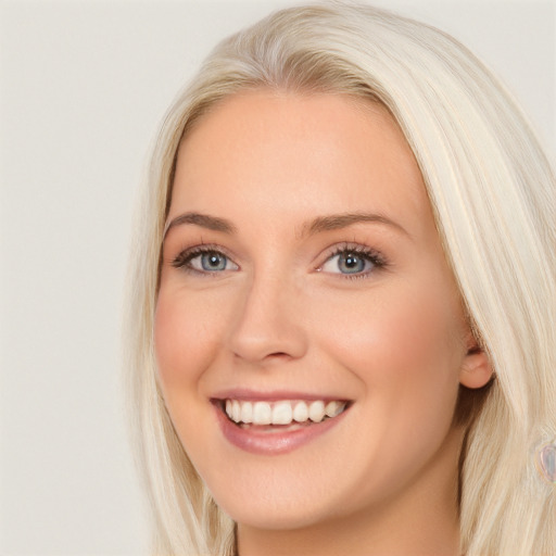 Joyful white young-adult female with long  brown hair and blue eyes