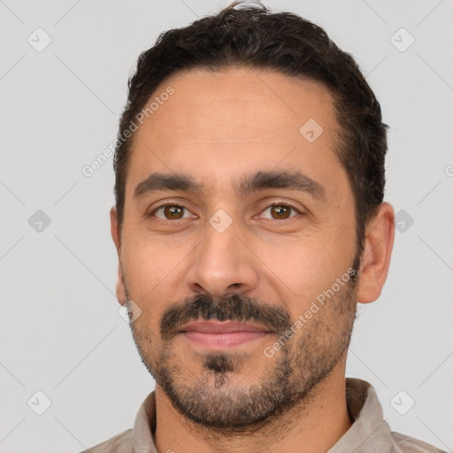 Joyful white young-adult male with short  black hair and brown eyes