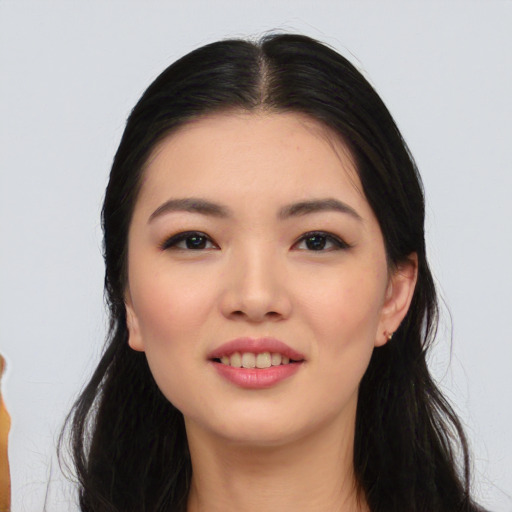 Joyful asian young-adult female with long  black hair and brown eyes