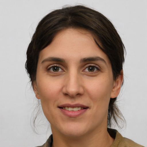 Joyful white young-adult female with medium  brown hair and brown eyes