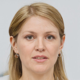 Joyful white adult female with long  brown hair and grey eyes