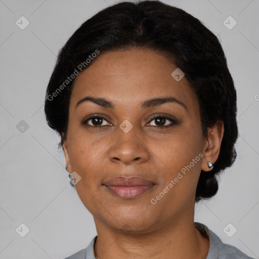 Joyful black young-adult female with short  black hair and brown eyes