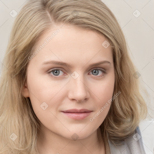 Joyful white young-adult female with long  brown hair and blue eyes