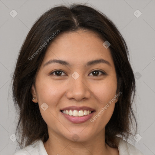 Joyful latino young-adult female with medium  brown hair and brown eyes