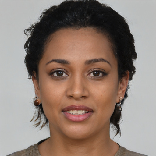 Joyful latino young-adult female with short  brown hair and brown eyes