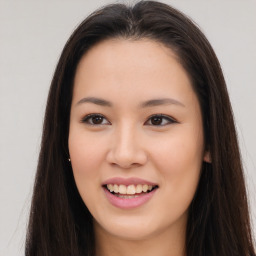 Joyful asian young-adult female with long  brown hair and brown eyes