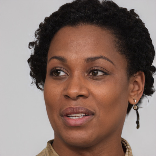 Joyful black adult female with short  brown hair and brown eyes