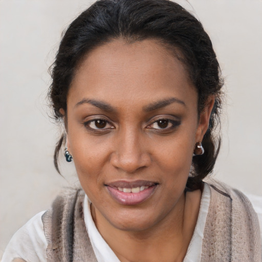 Joyful black young-adult female with short  brown hair and brown eyes