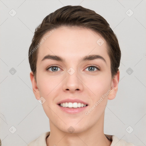 Joyful white young-adult female with short  brown hair and grey eyes