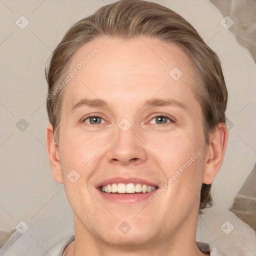 Joyful white adult male with short  brown hair and grey eyes