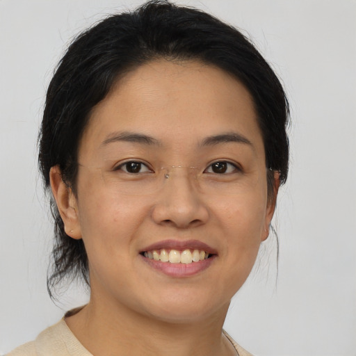 Joyful asian young-adult female with medium  brown hair and brown eyes