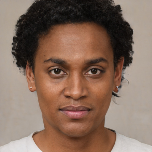 Joyful black young-adult male with short  black hair and brown eyes