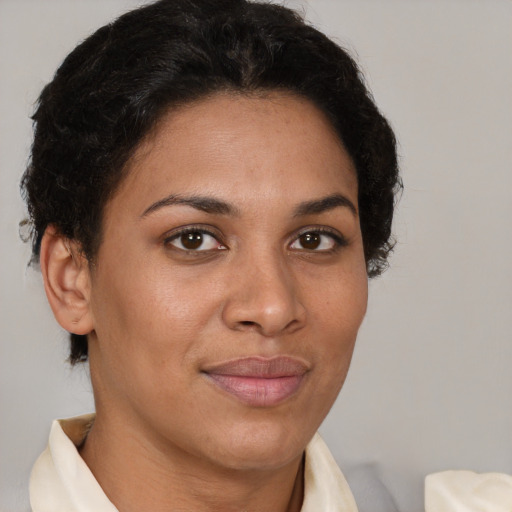 Joyful latino young-adult female with short  brown hair and brown eyes