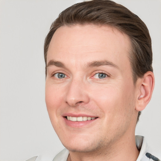 Joyful white adult male with short  brown hair and grey eyes