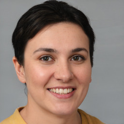 Joyful white young-adult female with medium  brown hair and brown eyes