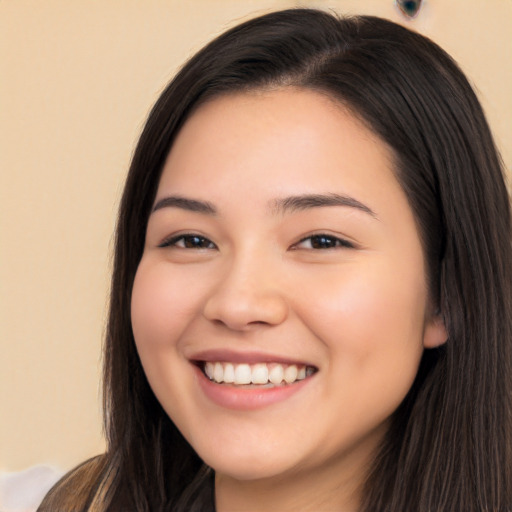 Joyful white young-adult female with long  black hair and brown eyes