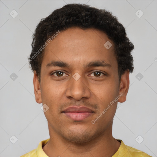 Joyful latino young-adult male with short  brown hair and brown eyes