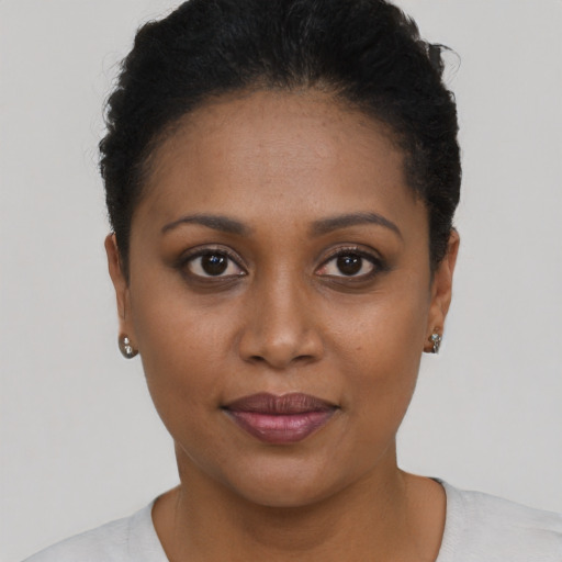 Joyful black young-adult female with short  brown hair and brown eyes