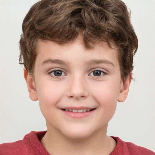 Joyful white child male with short  brown hair and grey eyes