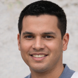 Joyful white young-adult male with short  black hair and brown eyes