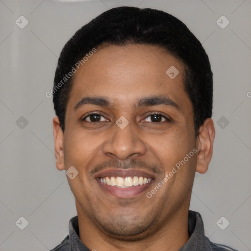 Joyful latino young-adult male with short  black hair and brown eyes