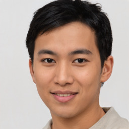 Joyful asian young-adult male with short  black hair and brown eyes