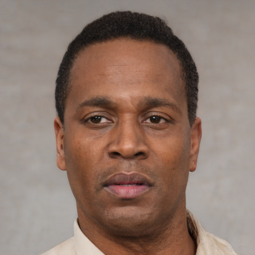 Neutral latino adult male with short  black hair and brown eyes