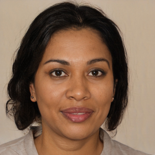 Joyful black young-adult female with medium  brown hair and brown eyes