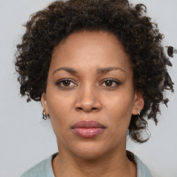 Joyful black adult female with short  brown hair and brown eyes