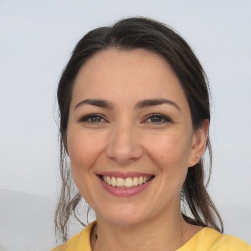 Joyful white young-adult female with medium  brown hair and brown eyes