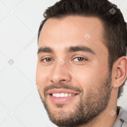 Joyful white young-adult male with short  black hair and brown eyes